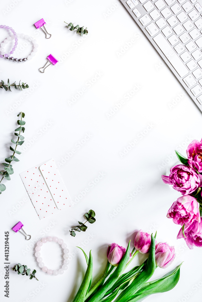 Spring flowers on workdesk at home white background top view mockup