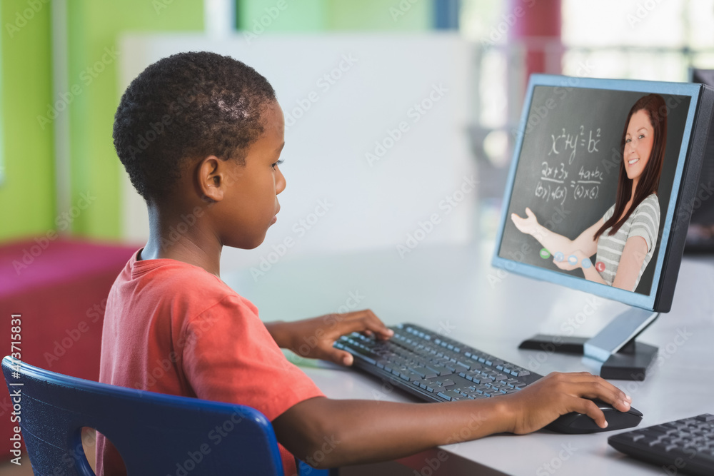 男非裔美国学生在学校用电脑与女老师视频通话