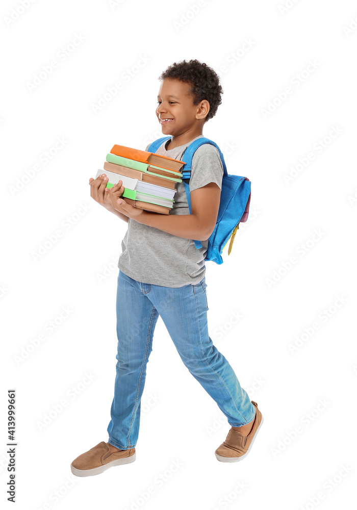 Little African-American schoolboy with books on white background