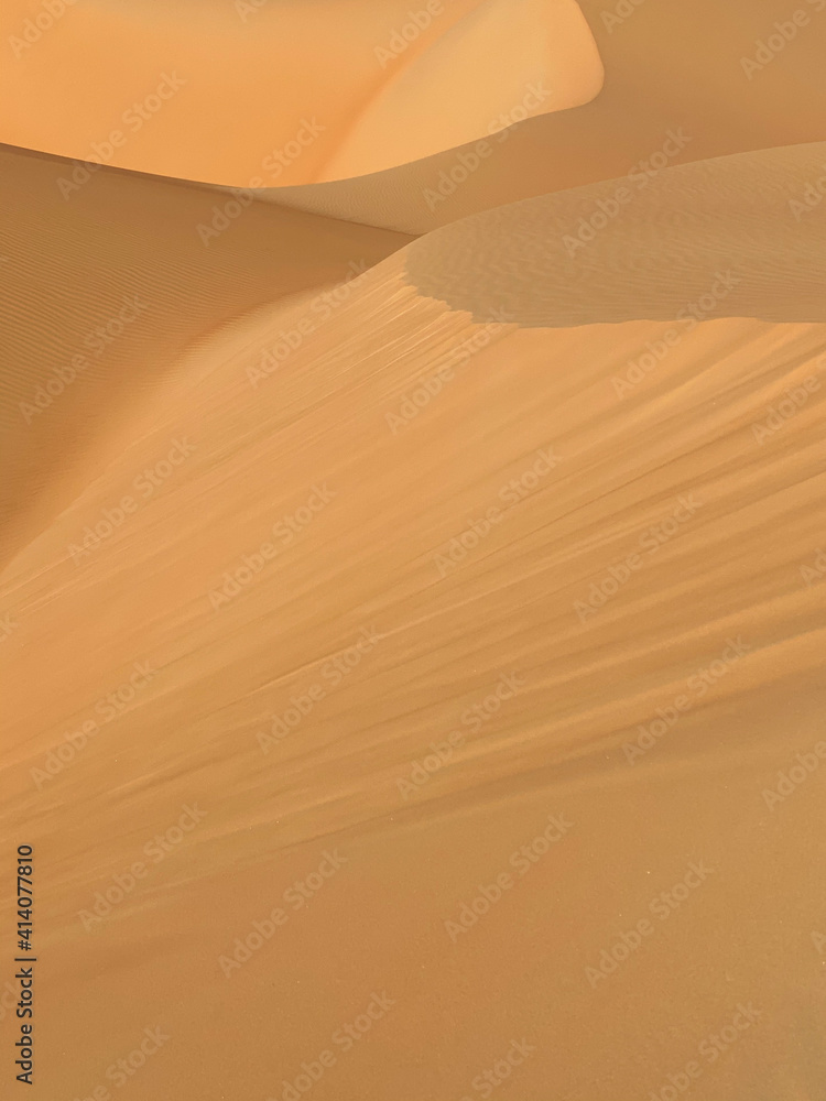 Simple abstract desert scenery with sand dunes and blue sky. Liwa desert, Abu Dhabi, UAE.
