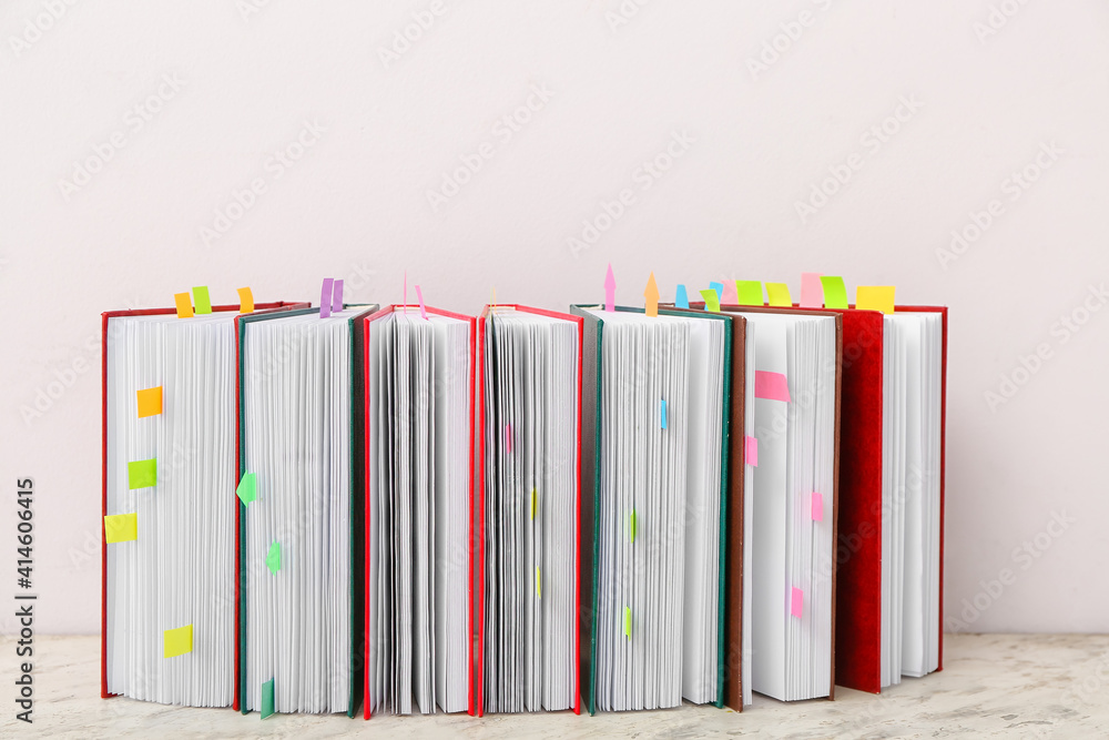 Many books with bookmarks on light background
