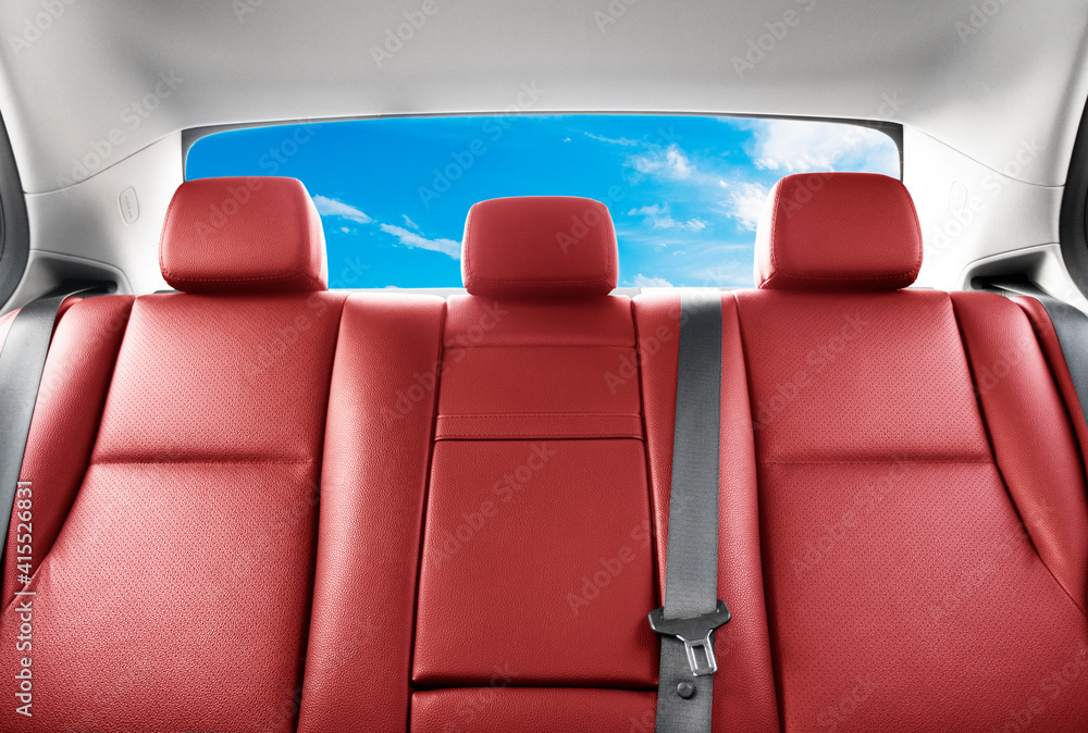 现代豪华车的后排乘客红色真皮座椅。红色穿孔皮革带缝线。车内