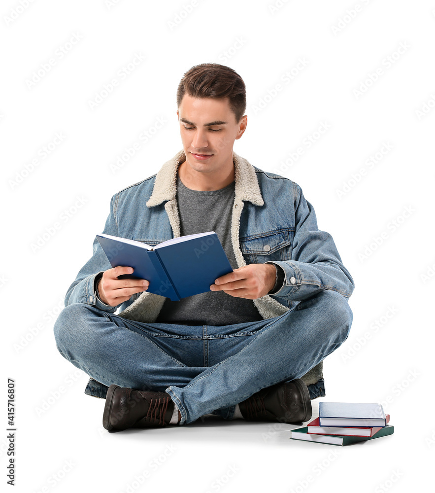 Young man reading books on white background