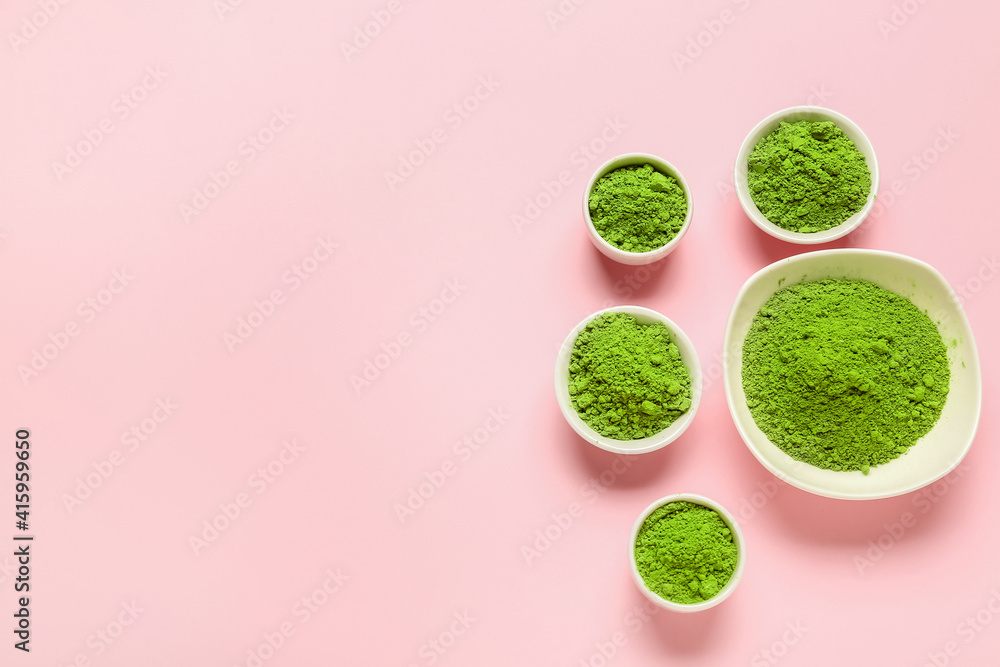 Bowls with powdered matcha tea on color background