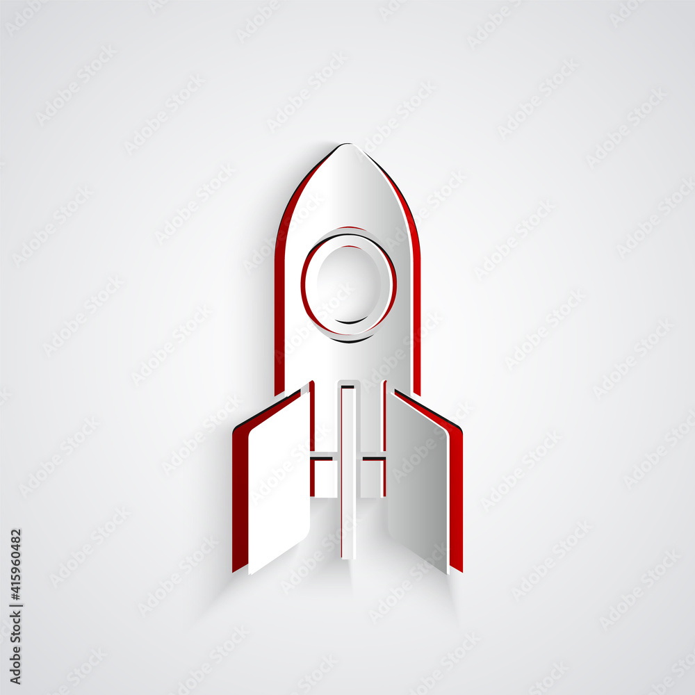 灰色背景上的剪纸火箭飞船图标。太空旅行。纸艺术风格。矢量。