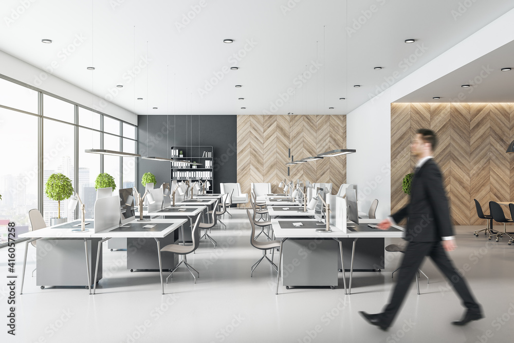 Blurry businessman silhouette in mosern light coworking office with light minimalistic furniture, wo