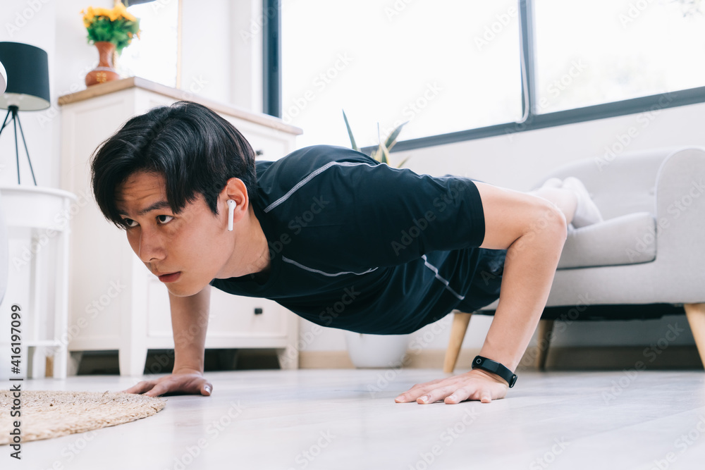 Young Asian man exercising at home