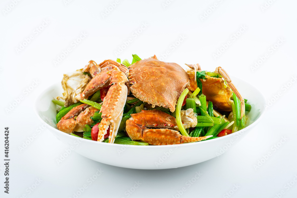 Fried flat crab with celery on a plate on white background