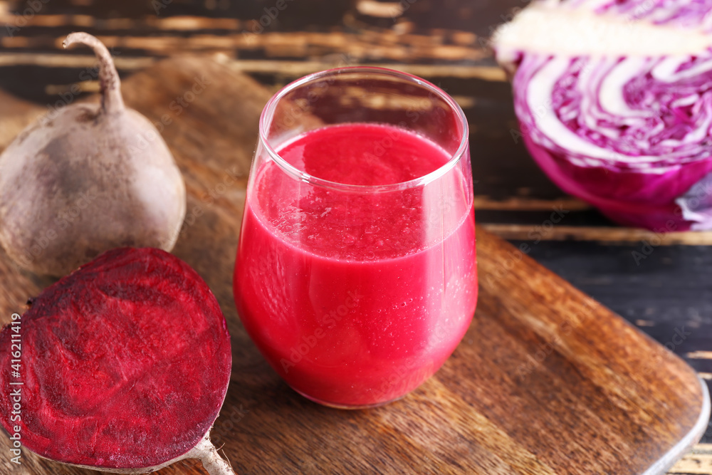 Glass of healthy smoothie with vegetables on wooden background