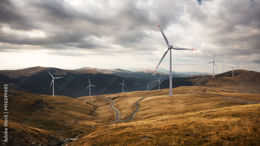 Green renewable alternative energy concept - wind generator turbines generating electricity. Landsca