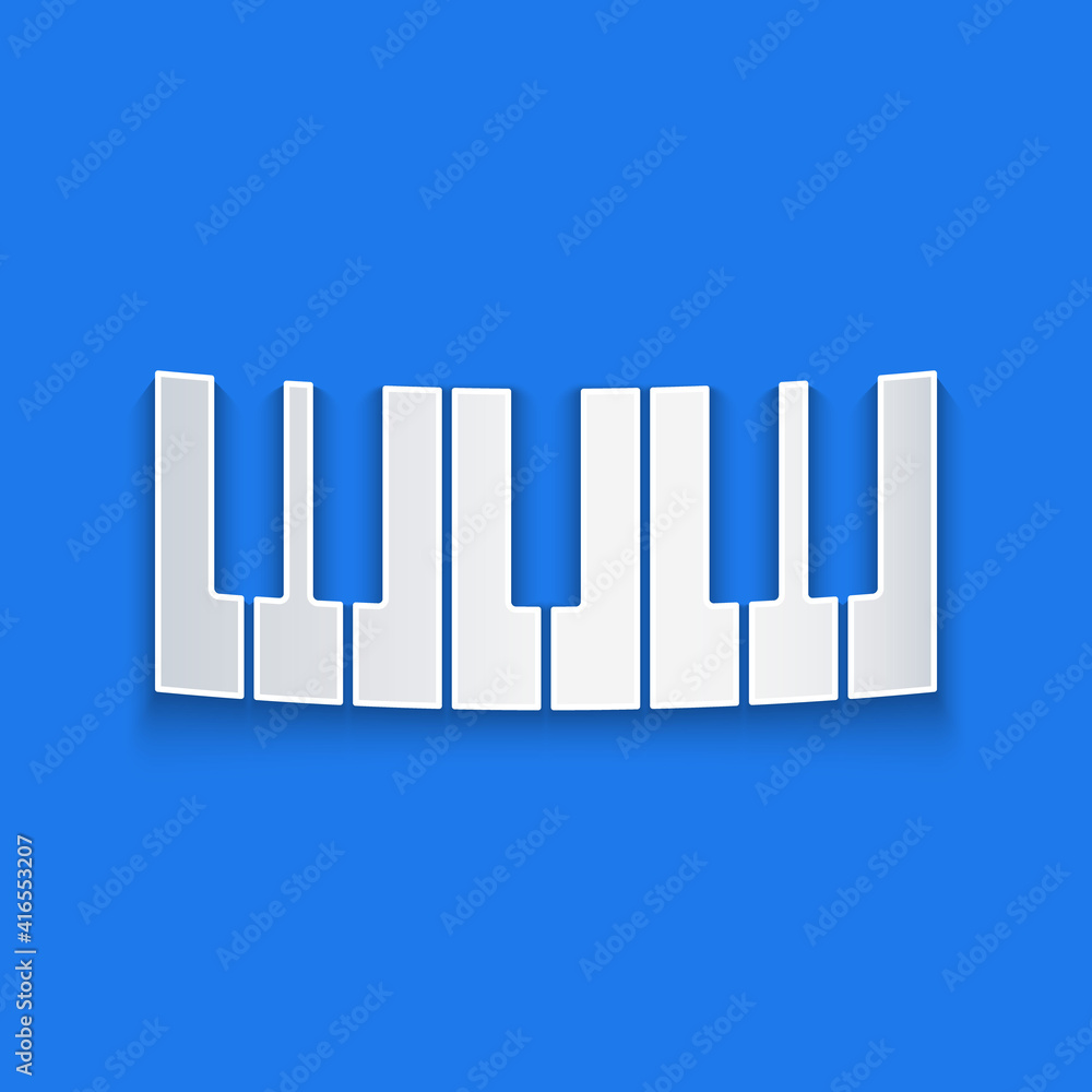 蓝色背景上的剪纸音乐合成器图标。电子钢琴。纸艺风格。Vec