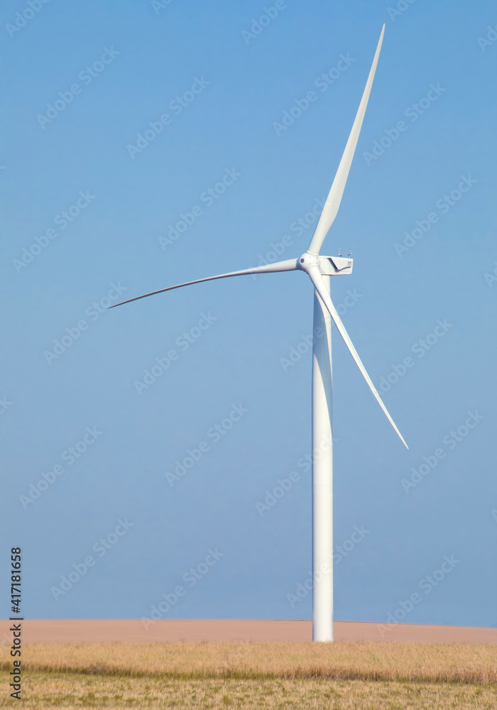 Big wind turbine on a background of blue sky.