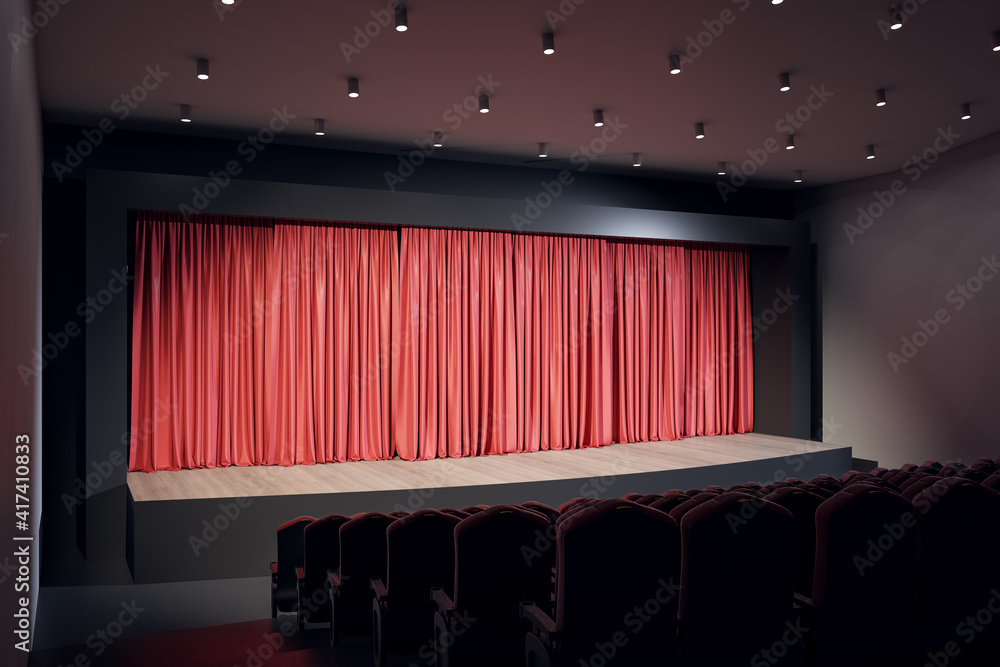空荡荡的大厅舞台上的聚光灯，红色窗帘，一排排红色天鹅绒座椅，顶部有灯