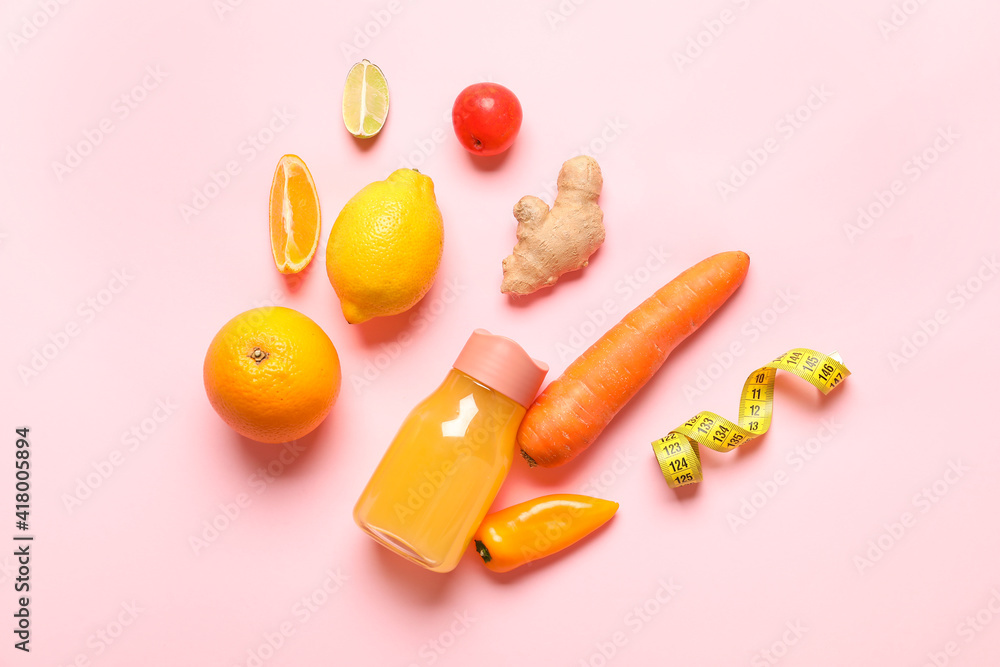彩色背景上的健康产品、卷尺和果汁瓶