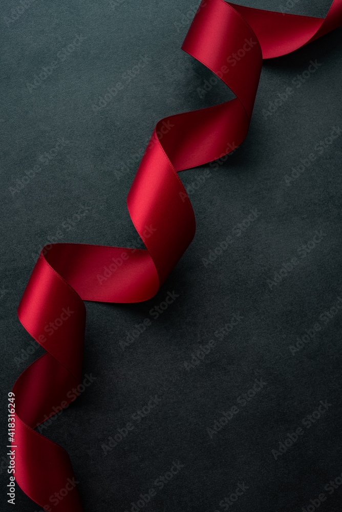 Red ribbon on black background