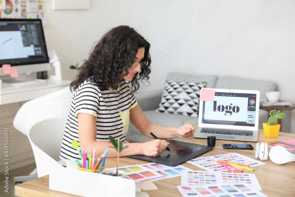 Young female designer working in office