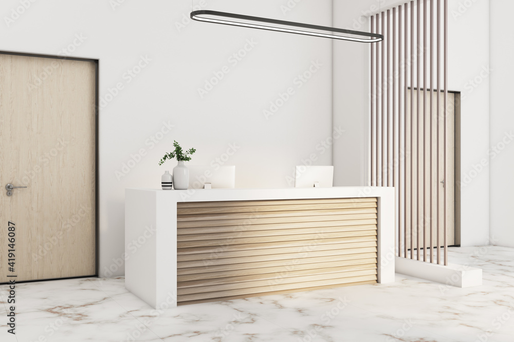 Eco style reception desk in sunny modern office with wooden slatted screen and marble floor