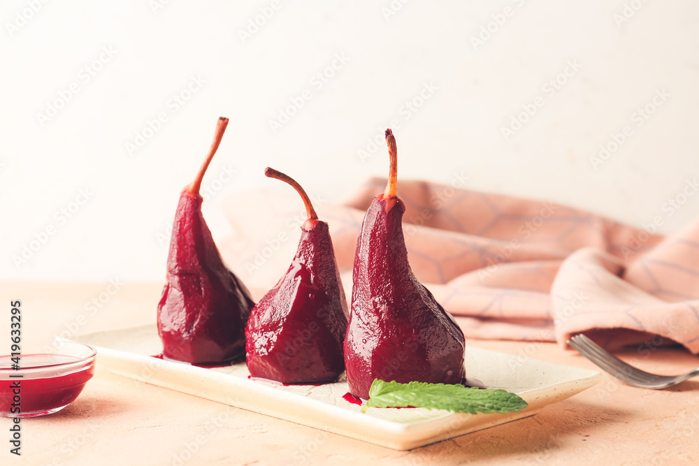 Plate of tasty poached pears in wine sauce on light background