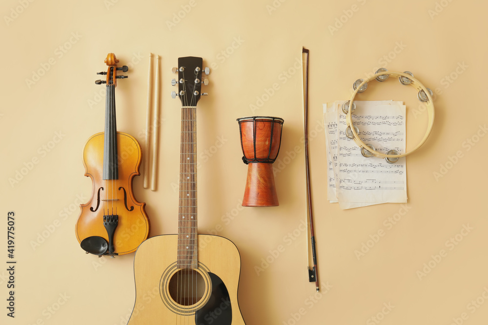 Different musical instruments and music notes on color background
