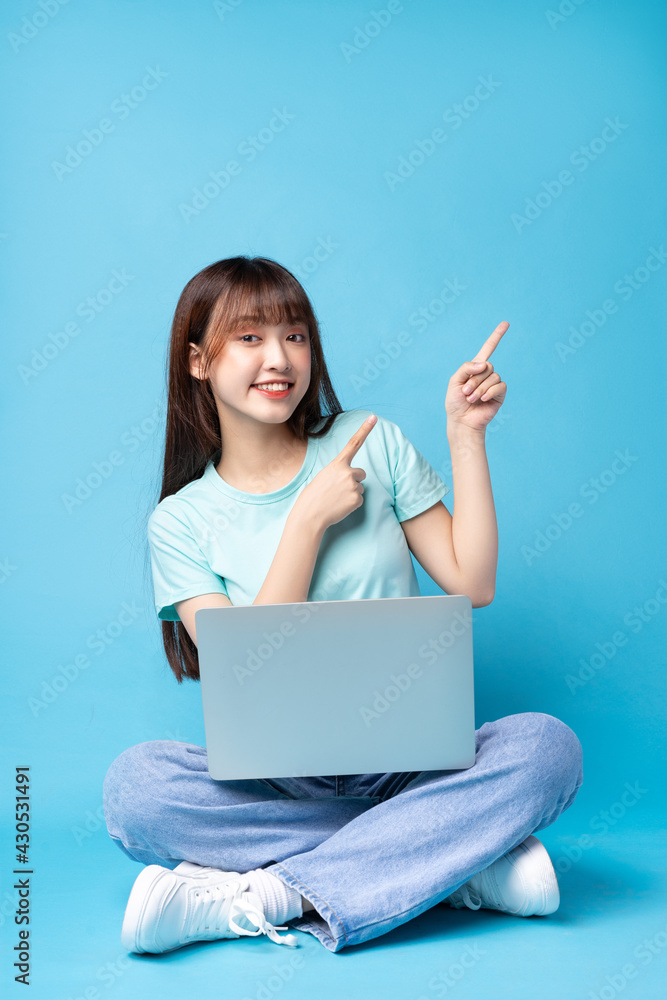 Image of young Asian girl on blue background