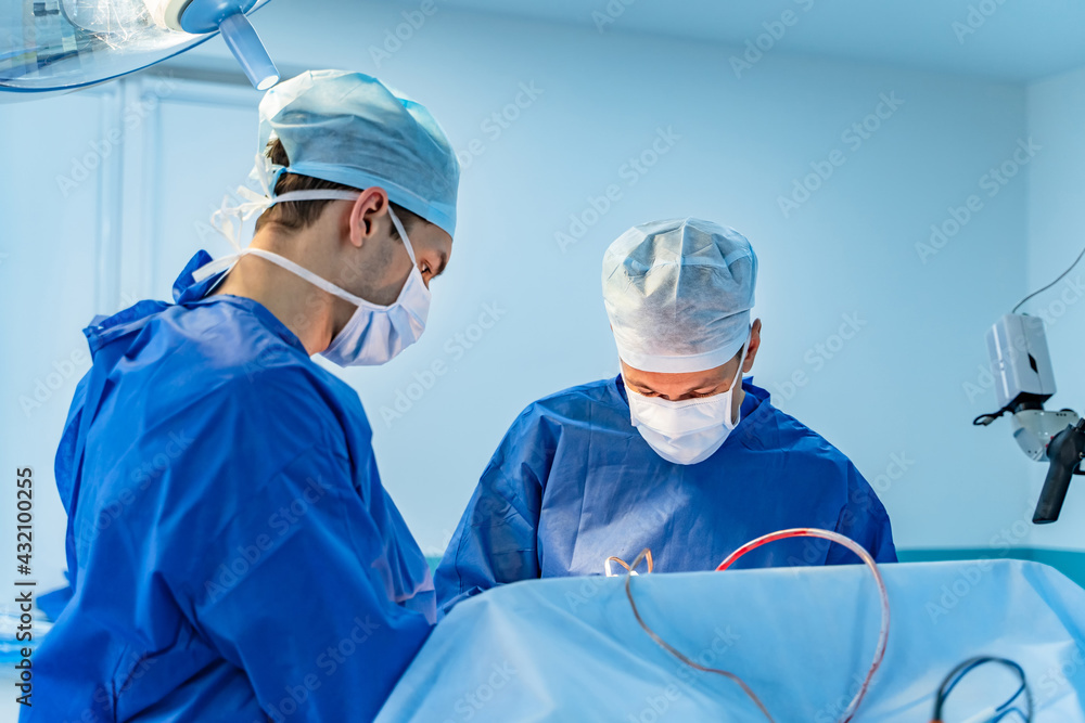 戴着医用口罩的现代神经外科。专业医院的团队合作手术。