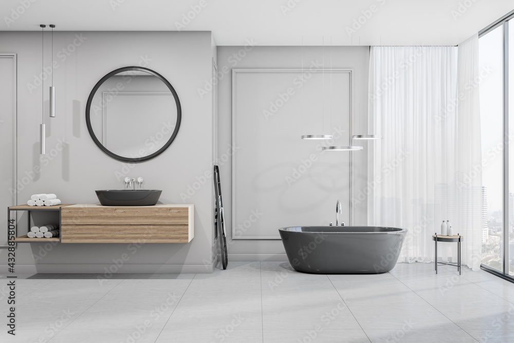 宽敞的浴室正视图，配有木制家具、水槽上方的圆形镜子、陶瓷故事地板a
