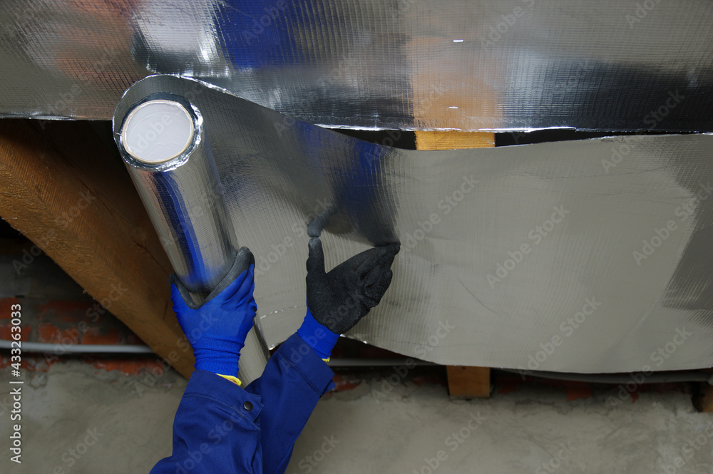 Builder attaches vapor barrier membrane