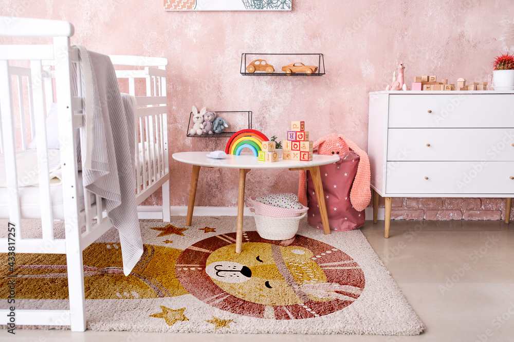 Stylish interior of modern childrens room with soft carpet