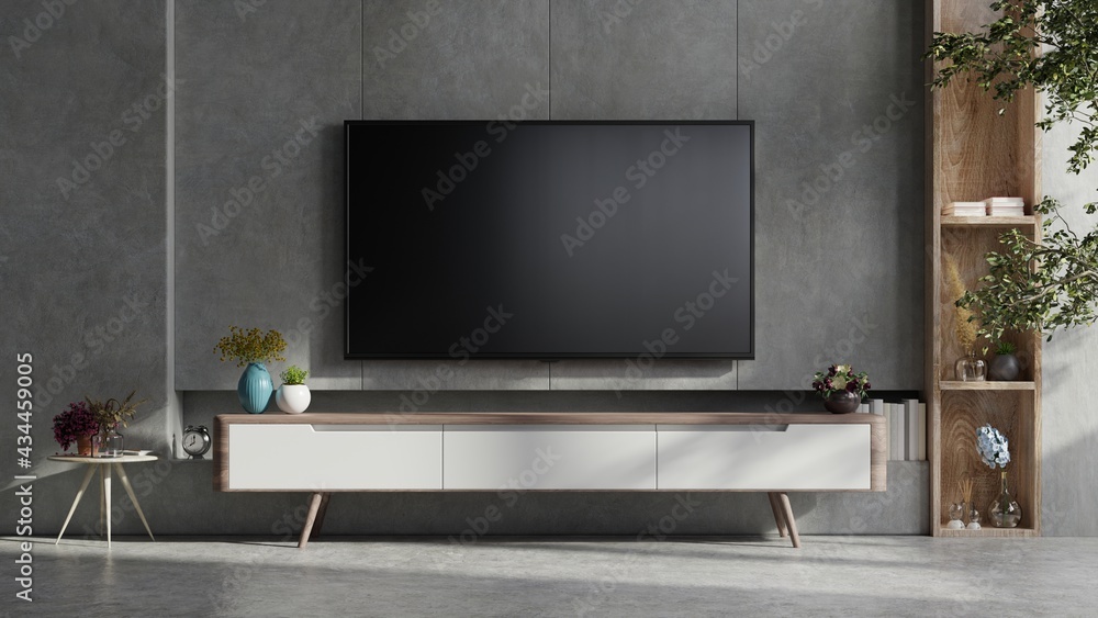 Mockup a TV wall mounted in a dark room with concrete wall.