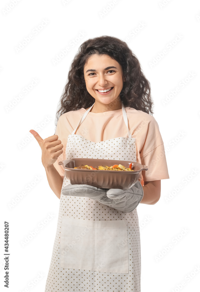 Young woman with baking dish showing thumb-up on white background