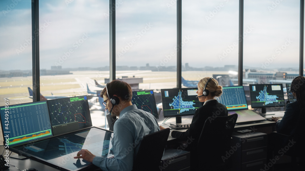 Diverse Air Traffic Control Team Working in a Modern Airport Tower. Office Room is Full of Desktop C