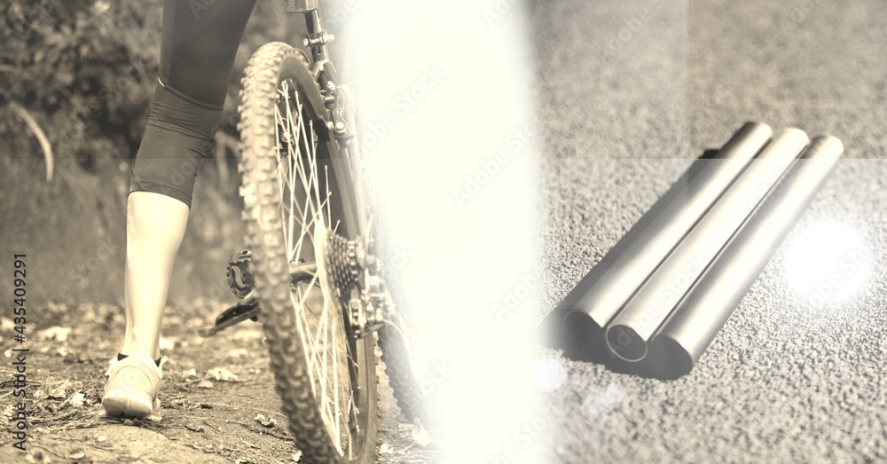 过度暴露的骑自行车者的低截面和道路上的金属管的成分，呈棕褐色