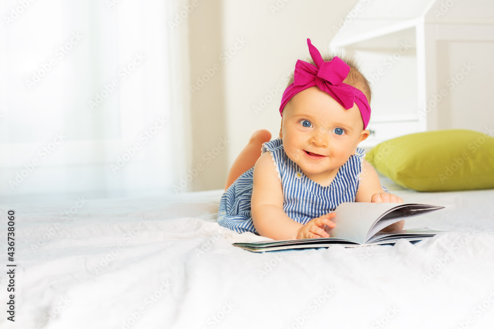 Portrait of stylish baby girl look through book