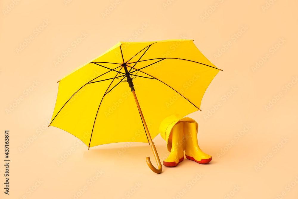 彩色背景的时尚雨伞和橡胶靴