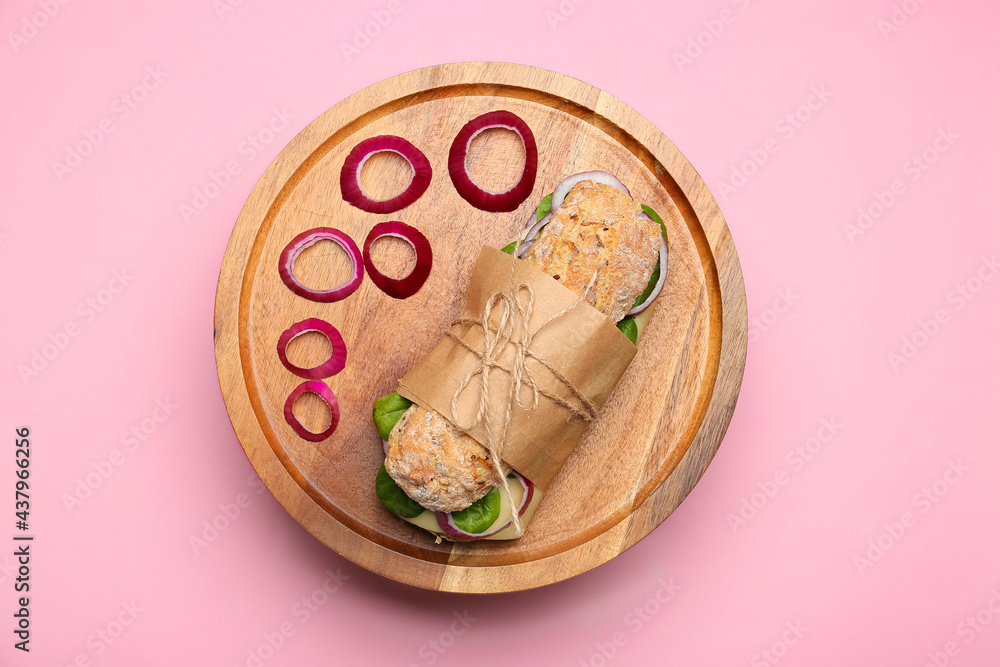 彩色背景上有美味的ciabatta三明治的木板
