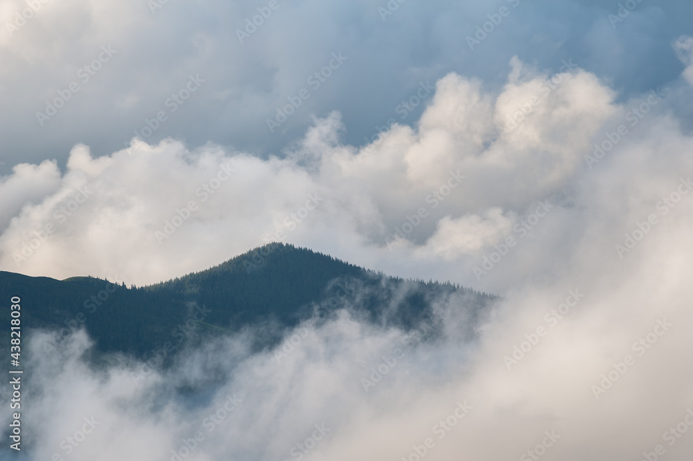 Low clouds and mountains silhouettes. Picturecque mountain landscape after the rain