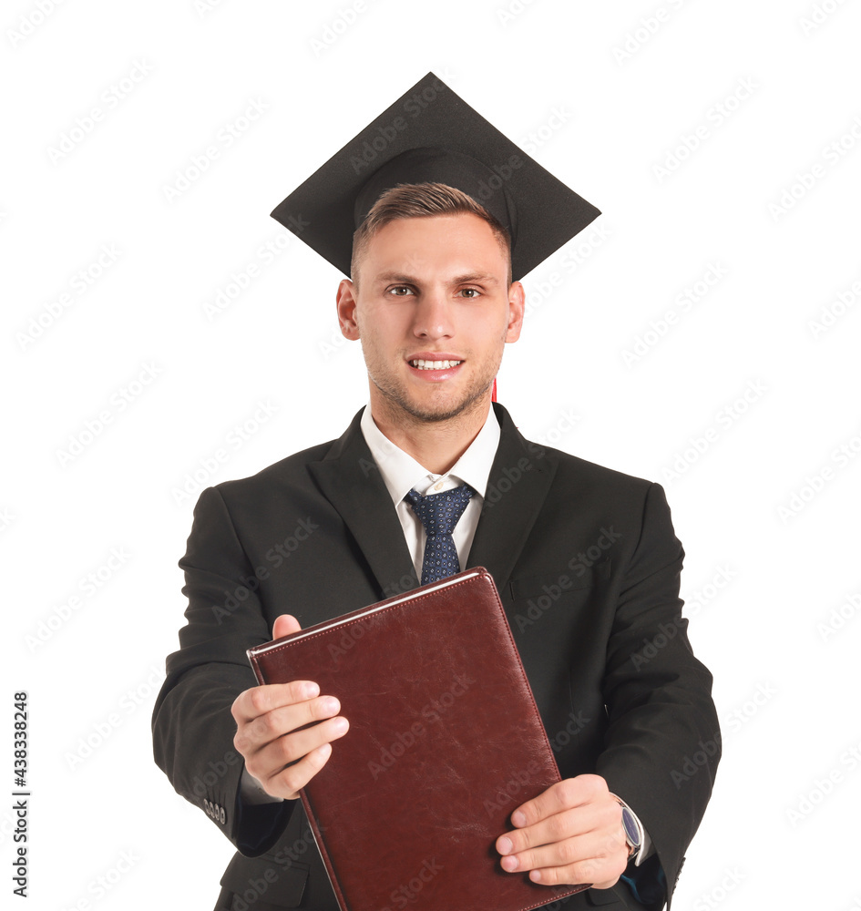 Male graduating student with book on white background