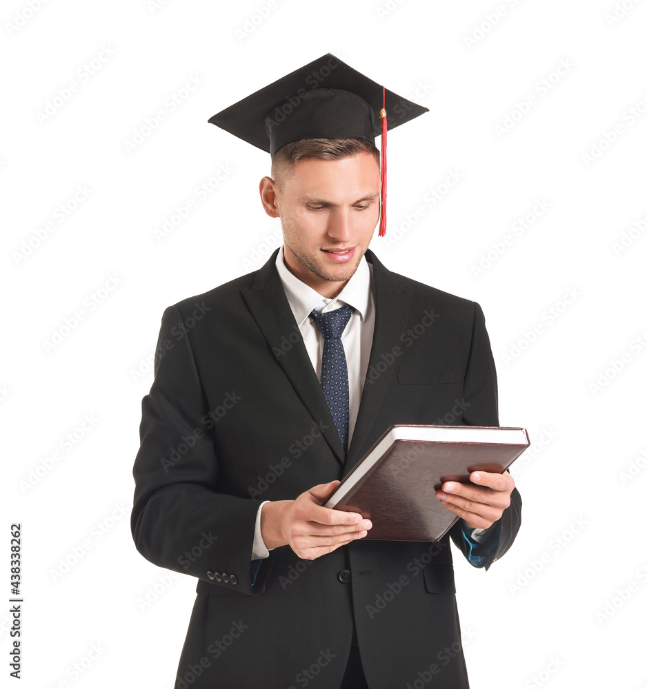 Male graduating student with book on white background