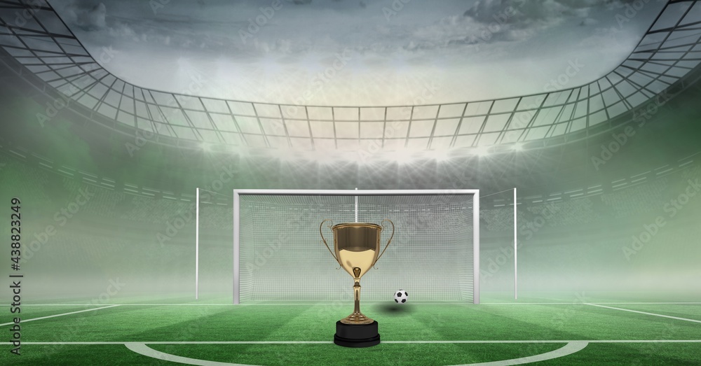 Composition of gold cup and football on football pitch and sports stadium