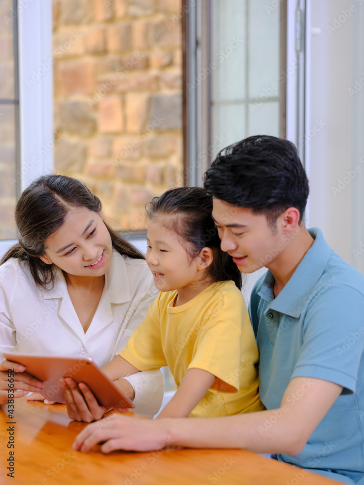 A Happy family of three using tablet