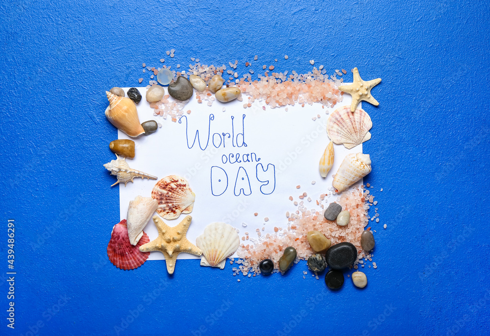 Paper sheet with text WORLD OCEAN DAY and sea shells on color background