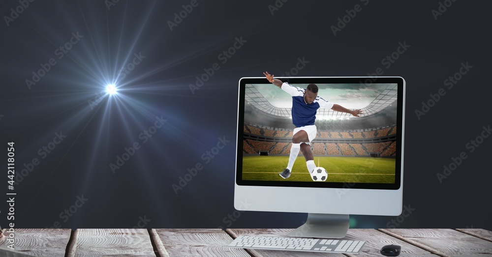 男子足球运动员在体育场用电脑踢球的构成