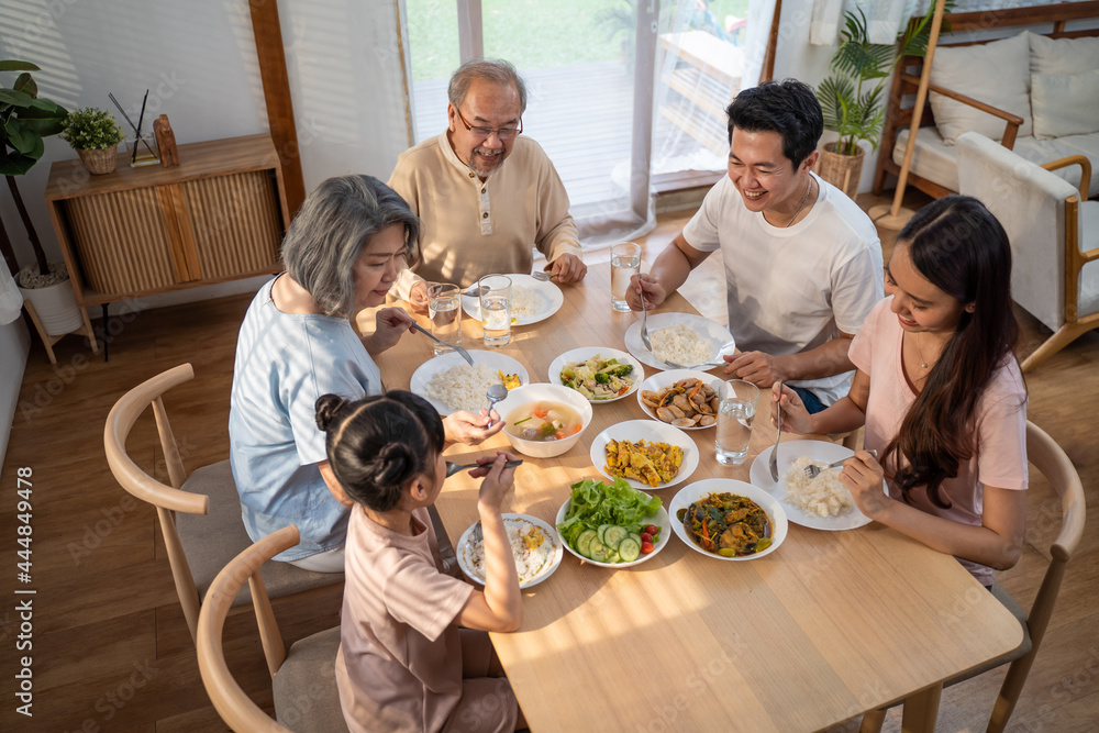 Asian Big happy family spend time have lunch on dinner table together.
