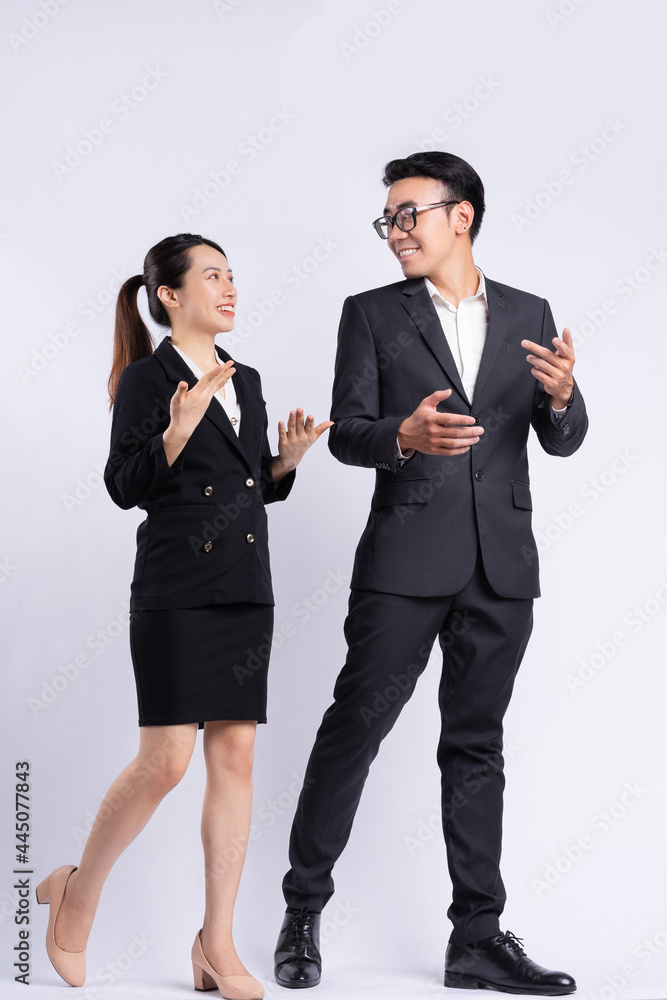 Asian businessman and businesswoman walking and talking on white background