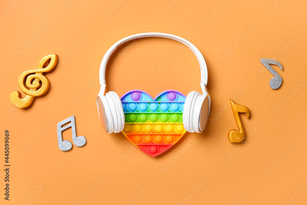 在彩色背景上弹出坐立不安的玩具、耳机和音乐笔记
