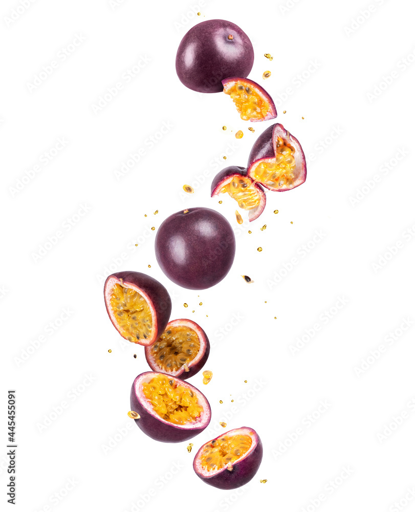 Whole and sliced fresh passion fruit (passiflora) in the air on a white background