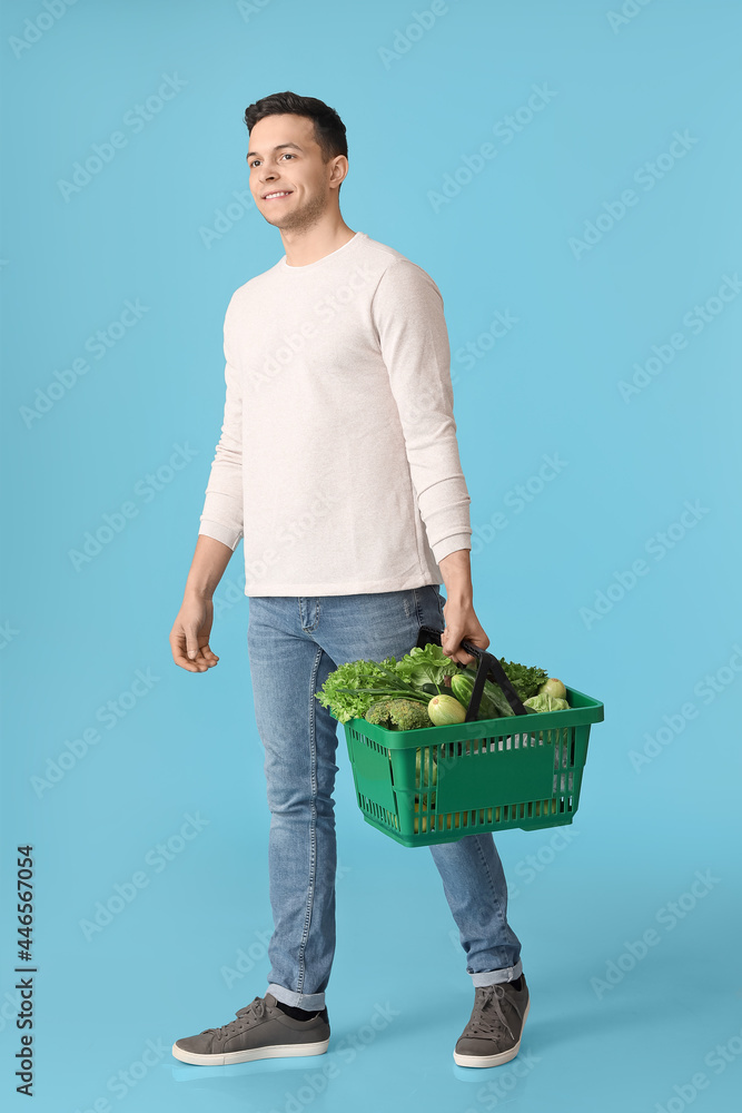 年轻人和购物篮，背景是新鲜蔬菜