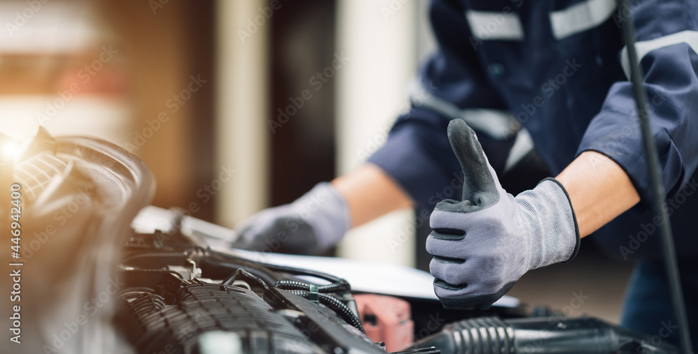 机修工在车库里修理汽车的发动机。维修服务。汽车检查服务的概念