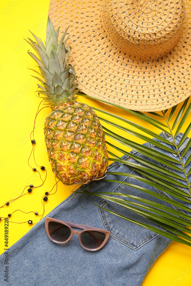 Set of female accessories with jeans and pineapple on color background, closeup