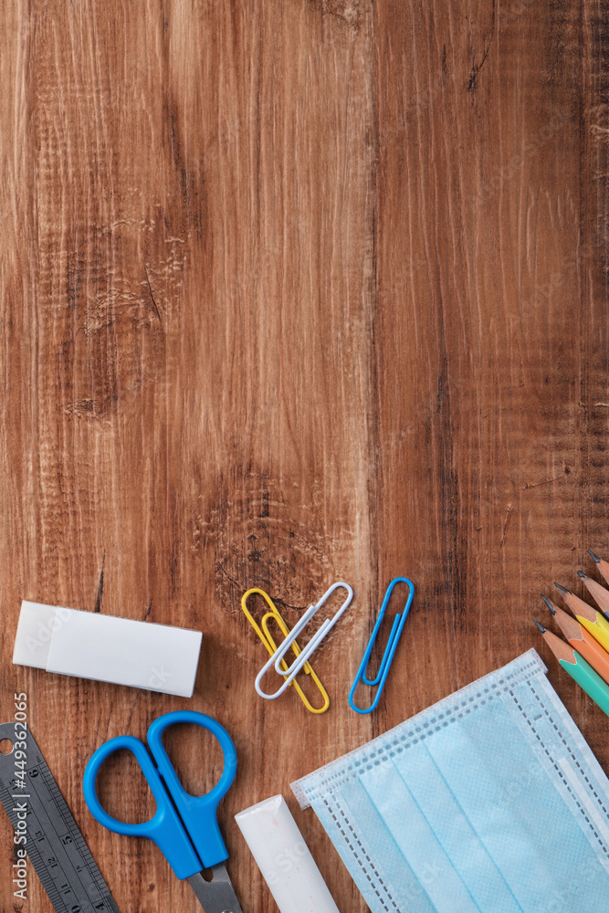 Back to school design concept with stationery over wooden table background.